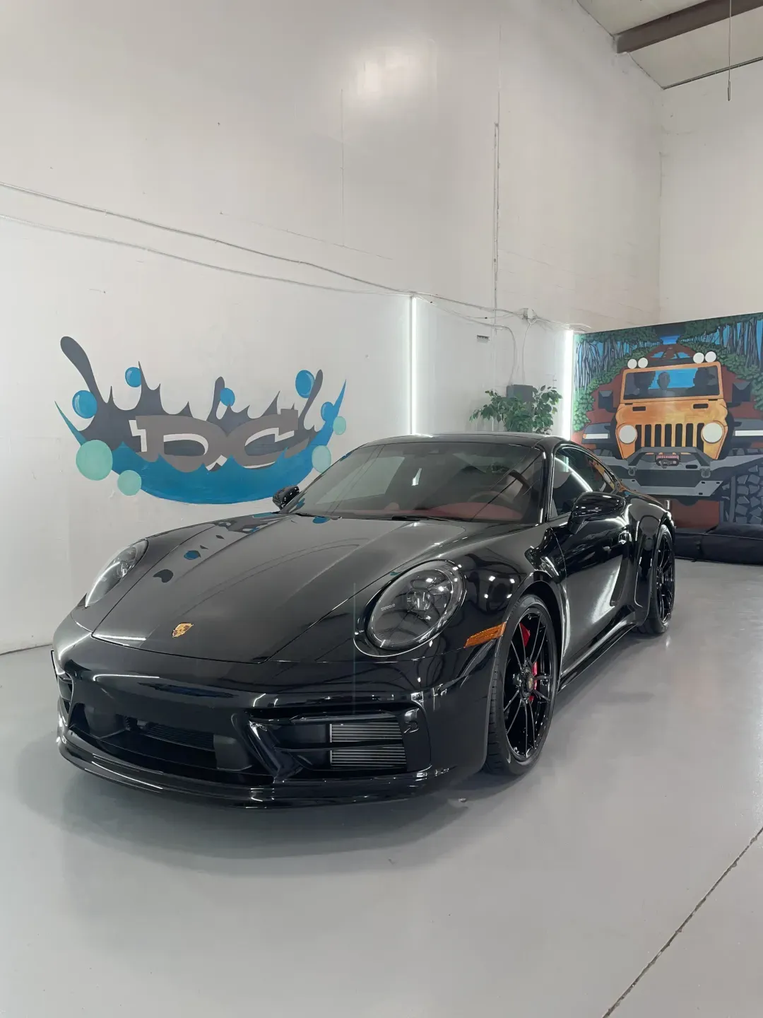 Black Porsche 911 with a fresh ceramic coating by Detail Champ